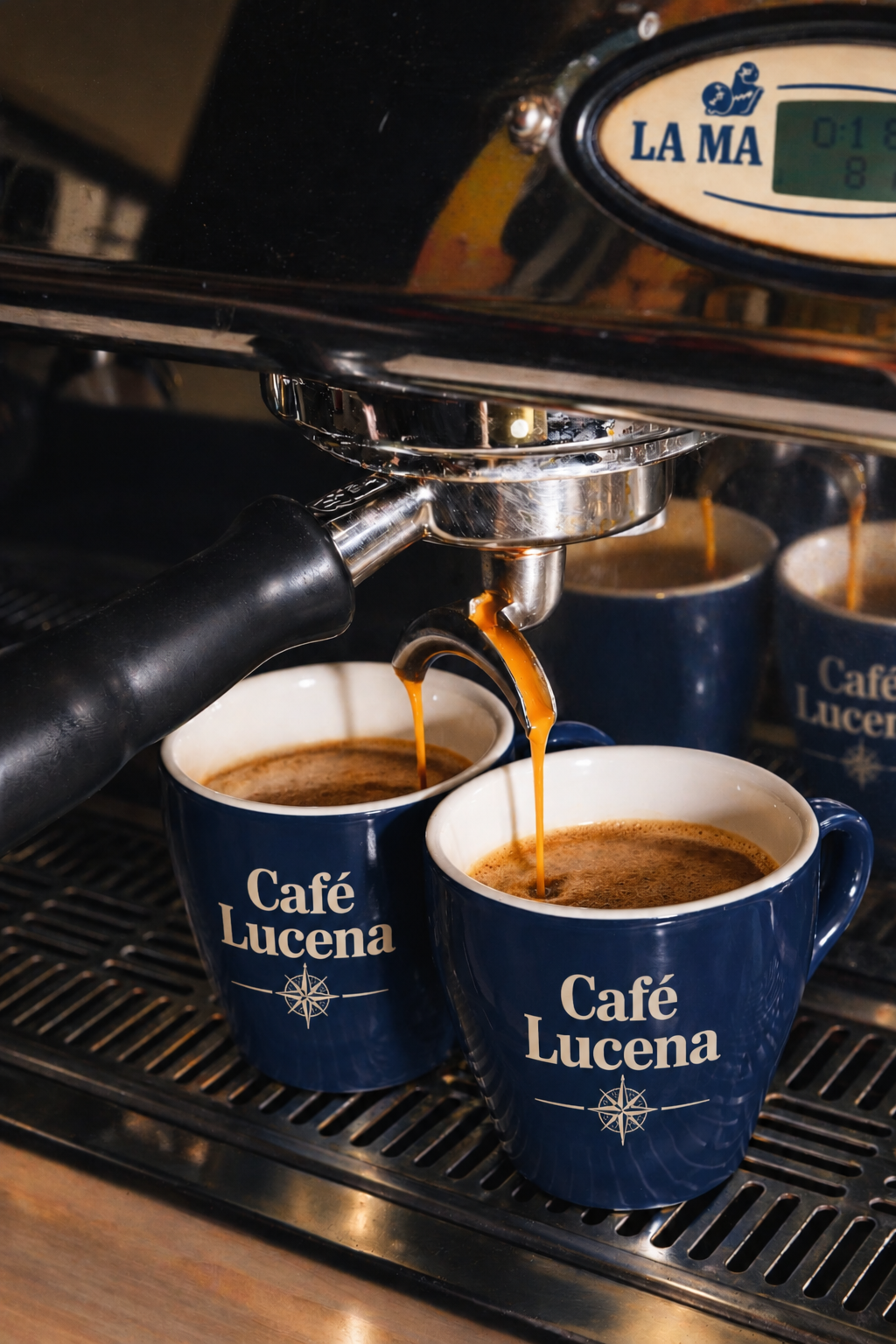 Espresso pouring into navy Café Lucena mugs